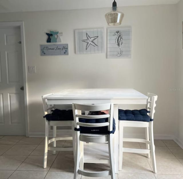6603 Adams St, New Port Richey, FL 34652 - dining area featuring light tile patterned floors and baseboards