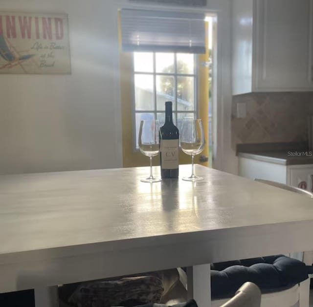 6603 Adams St, New Port Richey, FL 34652 - kitchen view of white cabinets and tasteful backsplash