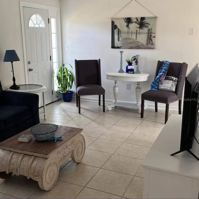 6603 Adams St, New Port Richey, FL 34652 - living area featuring light tile patterned floors and baseboards