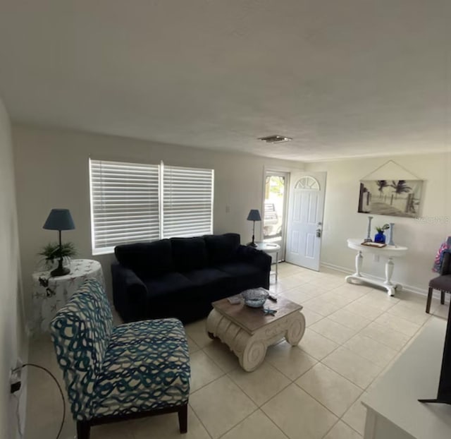 6603 Adams St, New Port Richey, FL 34652 - living room with light tile patterned floors and baseboards