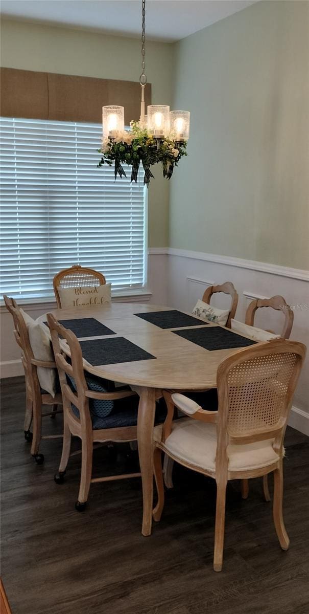 9967 Patrician Dr, New Port Richey, FL 34655 - dining room with a chandelier, wood finished floors, and wainscoting