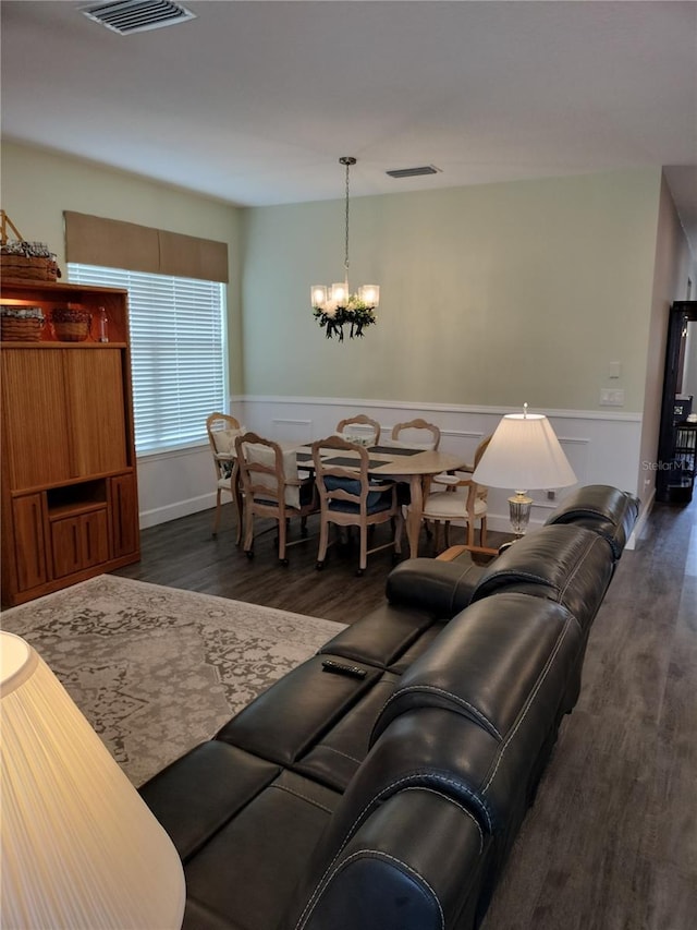 9967 Patrician Dr, New Port Richey, FL 34655 - living area with a chandelier, dark wood-type flooring, and wainscoting