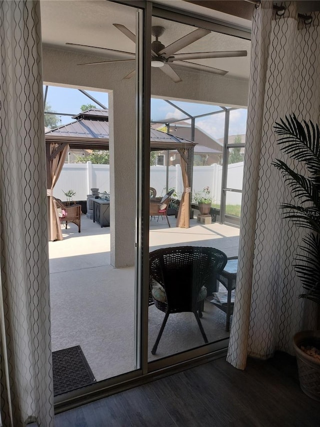 9967 Patrician Dr, New Port Richey, FL 34655 - doorway to outside featuring ceiling fan and wood finished floors