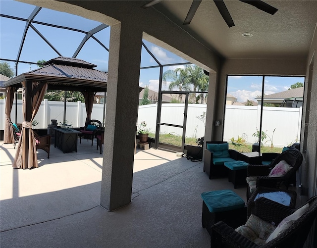 9967 Patrician Dr, New Port Richey, FL 34655 - fenced backyard with a patio, ceiling fan, an outdoor hangout area, and glass enclosure