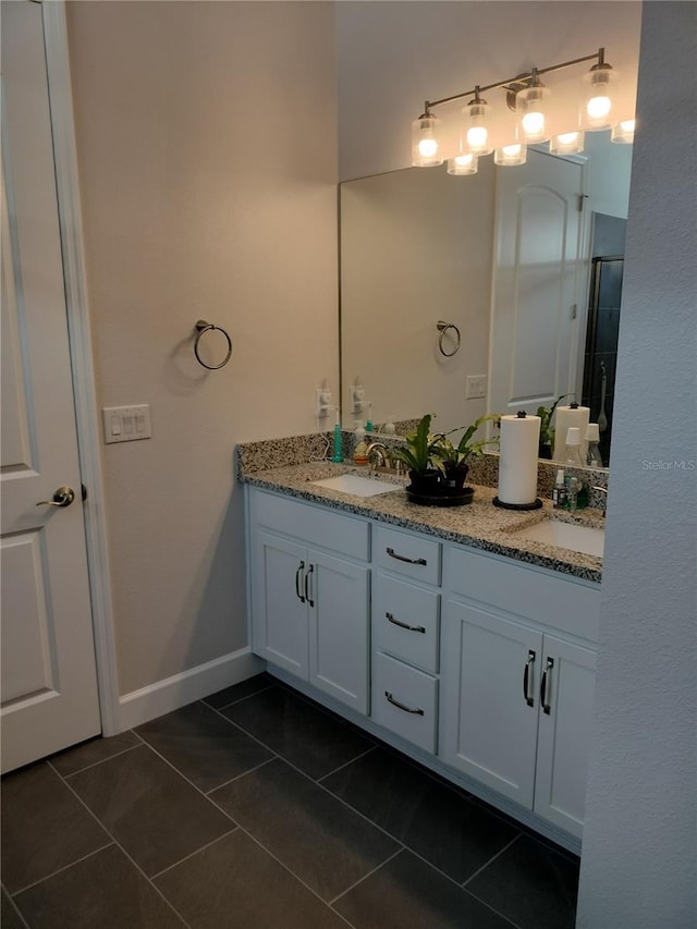 9967 Patrician Dr, New Port Richey, FL 34655 - full bath featuring double vanity, tile patterned flooring, and baseboards