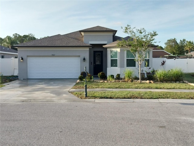 9967 Patrician Dr, New Port Richey, FL 34655 - view of front of house with an attached garage, concrete driveway, stucco siding, and a shingled roof