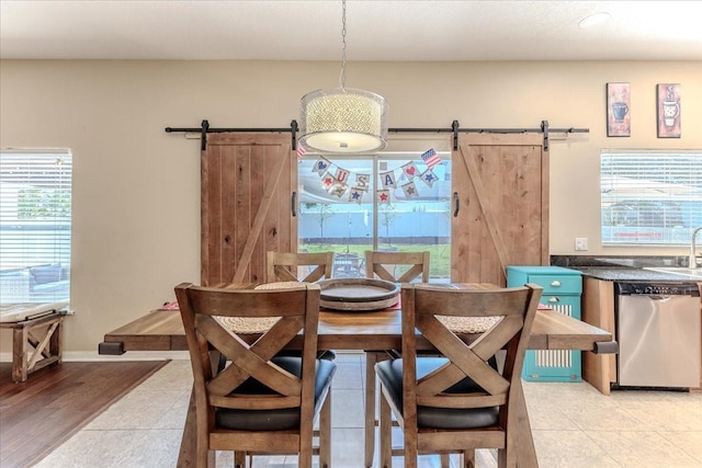 4094 Braemere Dr, Spring Hill, FL 34609 - dining room with a barn door and light tile patterned flooring