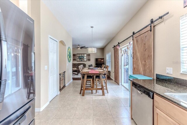 4094 Braemere Dr, Spring Hill, FL 34609 - dining space featuring a barn door, a ceiling fan, and light tile patterned floors