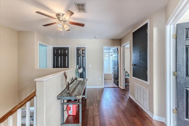 4094 Braemere Dr, Spring Hill, FL 34609 - hallway with dark wood-style floors, baseboards, an upstairs landing, and a textured ceiling