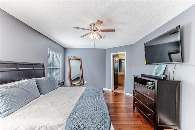 4094 Braemere Dr, Spring Hill, FL 34609 - bedroom featuring dark wood-style floors, a textured ceiling, a ceiling fan, baseboards, and ensuite bath