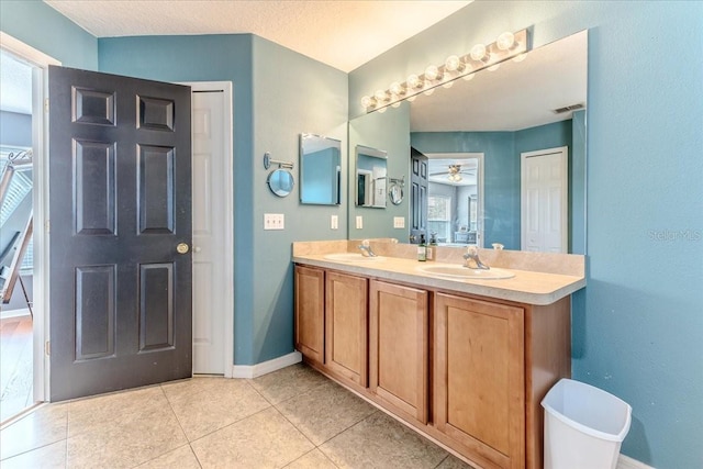 4094 Braemere Dr, Spring Hill, FL 34609 - full bath with double vanity, baseboards, ceiling fan, and tile patterned flooring