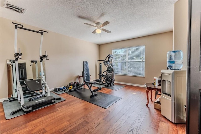 4094 Braemere Dr, Spring Hill, FL 34609 - workout area featuring wood finished floors, a ceiling fan, baseboards, and a textured ceiling