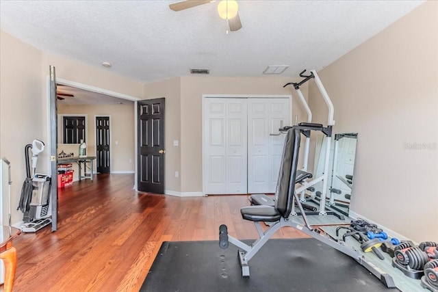 4094 Braemere Dr, Spring Hill, FL 34609 - workout room with ceiling fan, wood finished floors, and baseboards