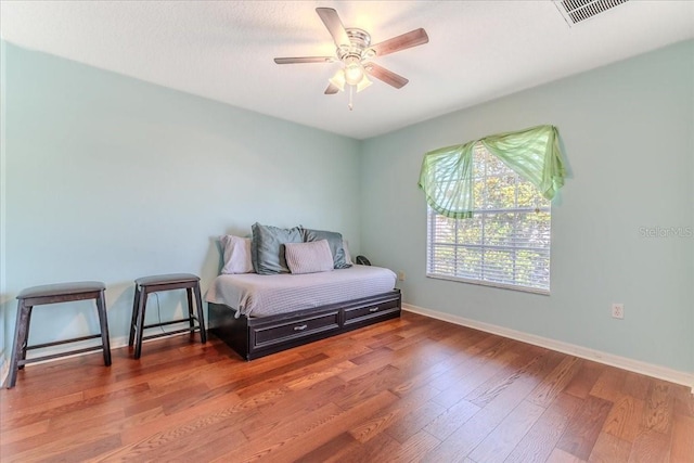 4094 Braemere Dr, Spring Hill, FL 34609 - bedroom featuring wood finished floors, baseboards, and ceiling fan