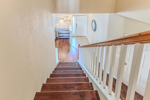 4094 Braemere Dr, Spring Hill, FL 34609 - stairway featuring a textured wall and wood finished floors