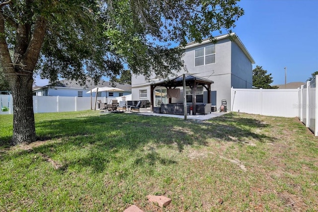 4094 Braemere Dr, Spring Hill, FL 34609 - back of property with a gazebo, an outdoor hangout area, a patio, and stucco siding
