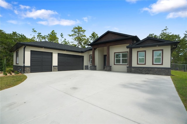 10380 Yellow Hammer Rd, Weeki Wachee, FL 34614 - view of front of property featuring stone siding, stucco siding, a garage, and driveway