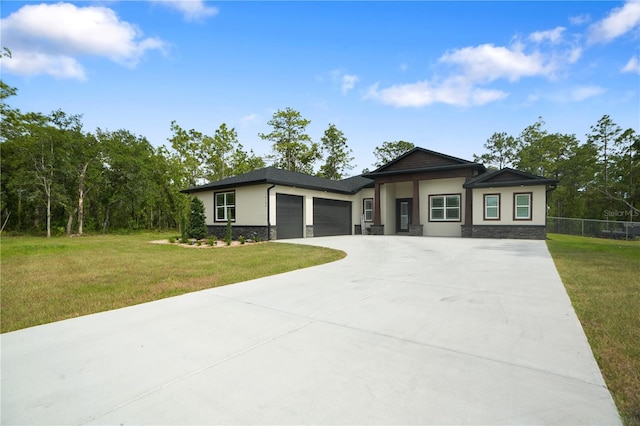 10380 Yellow Hammer Rd, Weeki Wachee, FL 34614 - prairie-style house with stucco siding, a garage, concrete driveway, and stone siding