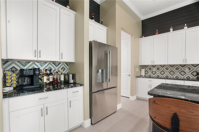 10380 Yellow Hammer Rd, Weeki Wachee, FL 34614 - kitchen featuring stainless steel refrigerator with ice dispenser, white cabinetry, ornamental molding, tasteful backsplash, and light wood-style floors