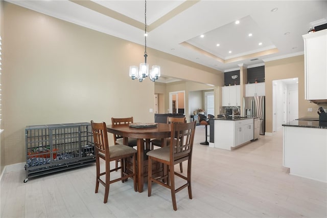 10380 Yellow Hammer Rd, Weeki Wachee, FL 34614 - dining space featuring a raised ceiling, light wood finished floors, a chandelier, recessed lighting, and crown molding