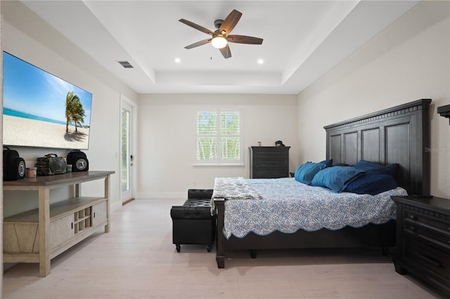 10380 Yellow Hammer Rd, Weeki Wachee, FL 34614 - bedroom featuring a tray ceiling, light wood-type flooring, recessed lighting, ceiling fan, and baseboards