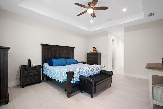 10380 Yellow Hammer Rd, Weeki Wachee, FL 34614 - bedroom with a tray ceiling, light wood-style floors, recessed lighting, baseboards, and ceiling fan