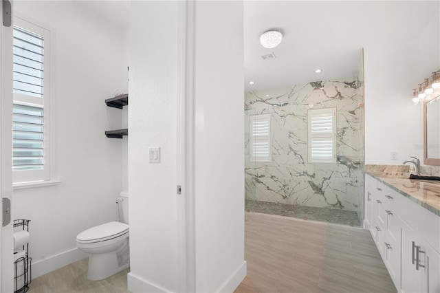 10380 Yellow Hammer Rd, Weeki Wachee, FL 34614 - bathroom with toilet, plenty of natural light, a marble finish shower, and vanity