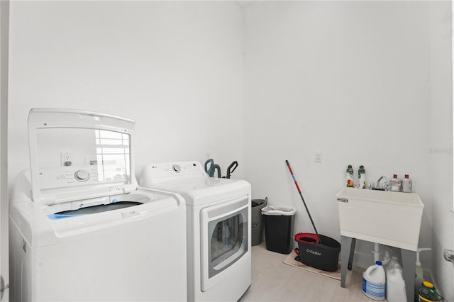 10380 Yellow Hammer Rd, Weeki Wachee, FL 34614 - washroom featuring washer and dryer and light wood finished floors