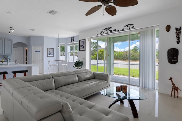 4215 Maplehurst Way, Spring Hill, FL 34609 - living room featuring a ceiling fan, arched walkways, and light tile patterned floors