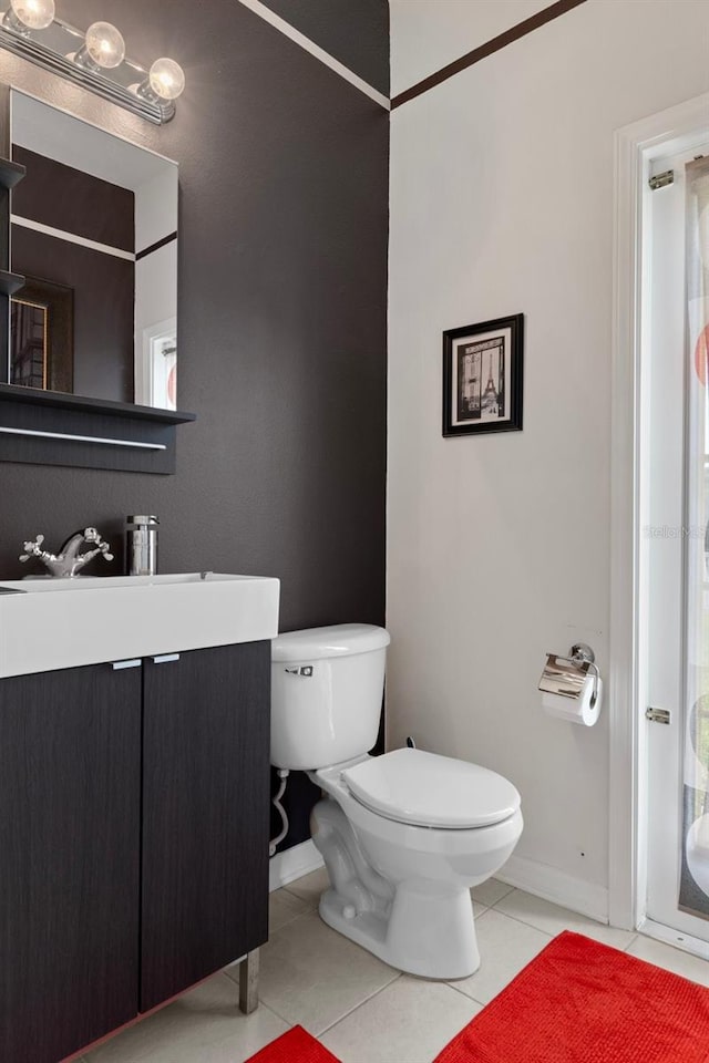 4215 Maplehurst Way, Spring Hill, FL 34609 - bathroom featuring toilet, tile patterned floors, vanity, and baseboards