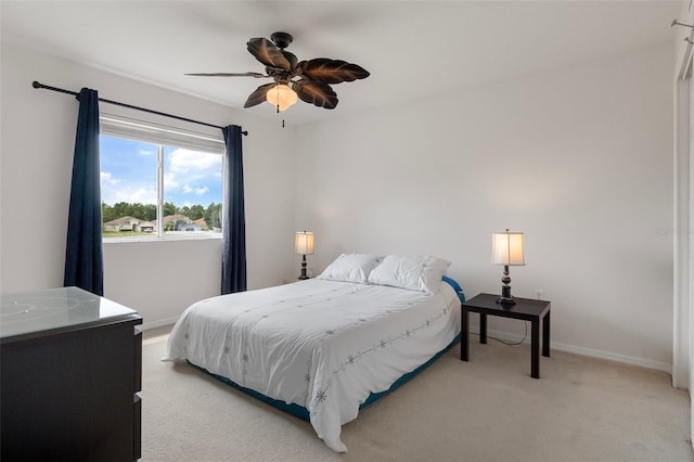 4215 Maplehurst Way, Spring Hill, FL 34609 - bedroom with light carpet, baseboards, and a ceiling fan