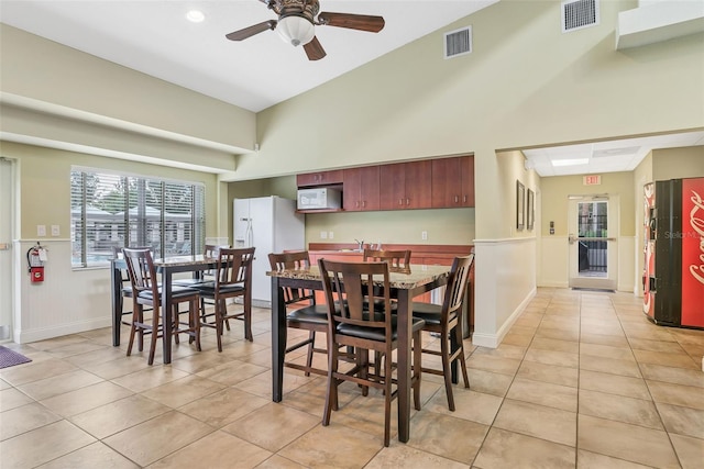 4215 Maplehurst Way, Spring Hill, FL 34609 - dining room featuring light tile patterned flooring, ceiling fan, and a high ceiling