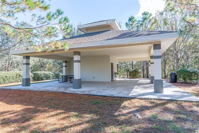 4215 Maplehurst Way, Spring Hill, FL 34609 - rear view of property with stucco siding, a shingled roof, and a carport