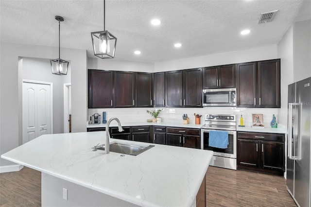 7523 Tangle Brook Blvd, Gibsonton, FL 33534 - kitchen featuring appliances with stainless steel finishes, a sink, dark wood-style flooring, backsplash, and a textured ceiling