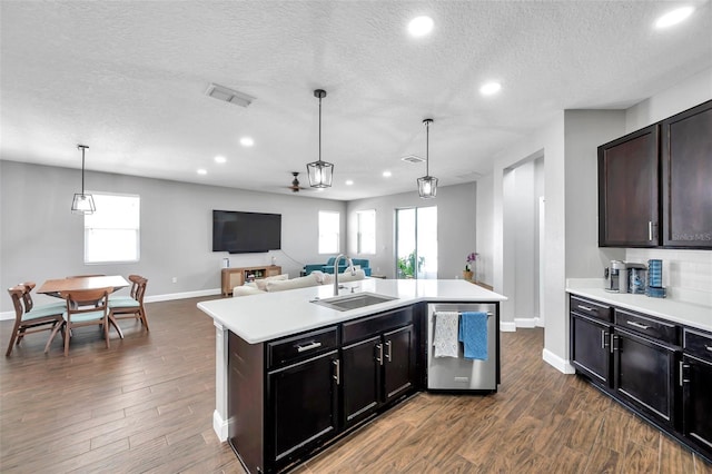 7523 Tangle Brook Blvd, Gibsonton, FL 33534 - kitchen featuring a sink, dishwasher, light countertops, open floor plan, and a textured ceiling