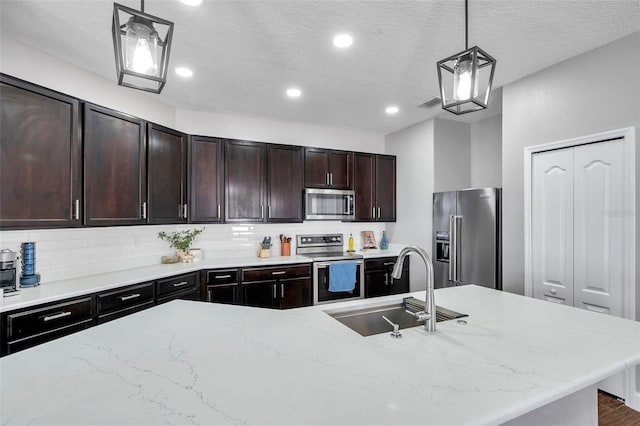 7523 Tangle Brook Blvd, Gibsonton, FL 33534 - kitchen with stainless steel appliances, a sink, decorative backsplash, light stone countertops, and recessed lighting