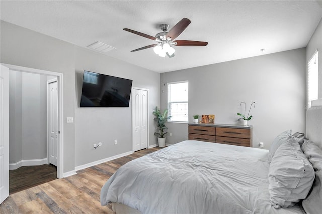 7523 Tangle Brook Blvd, Gibsonton, FL 33534 - bedroom featuring wood finished floors, baseboards, and ceiling fan