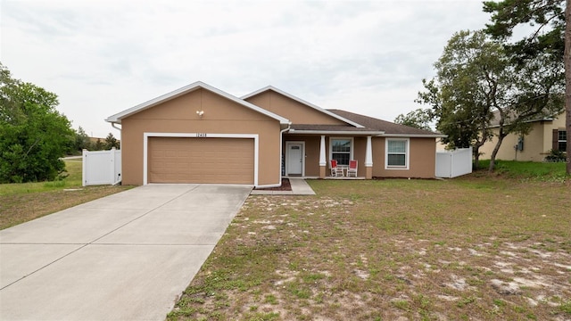 12458 Fish Cove Dr, Spring Hill, FL 34609 - single story home with a garage, stucco siding, driveway, and a porch