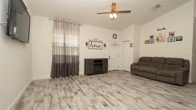 12458 Fish Cove Dr, Spring Hill, FL 34609 - living room with light wood-style flooring, a ceiling fan, and baseboards