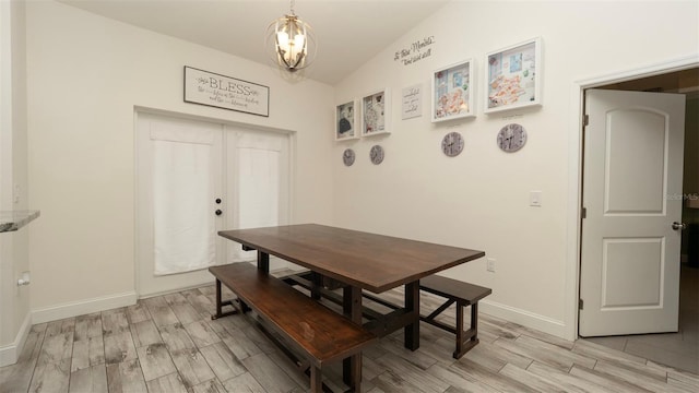 12458 Fish Cove Dr, Spring Hill, FL 34609 - dining area with light wood-type flooring, a chandelier, baseboards, and vaulted ceiling