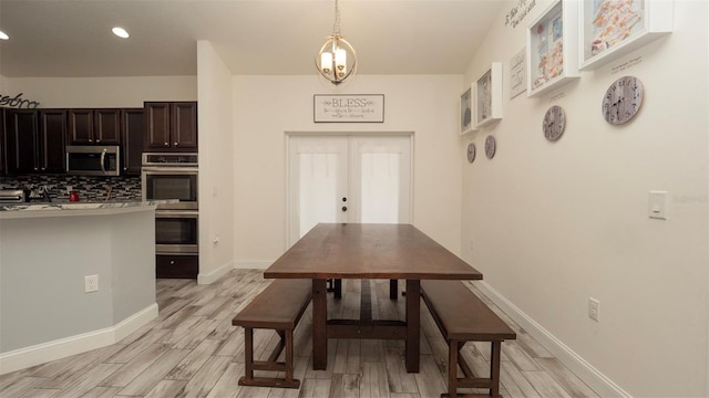 12458 Fish Cove Dr, Spring Hill, FL 34609 - dining room with light wood-type flooring, recessed lighting, and baseboards
