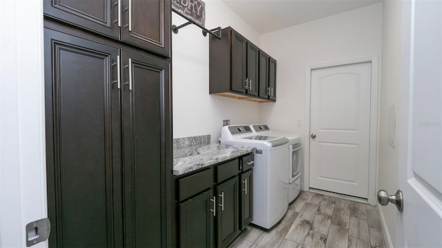 12458 Fish Cove Dr, Spring Hill, FL 34609 - laundry room featuring cabinet space, separate washer and dryer, and light wood-style floors