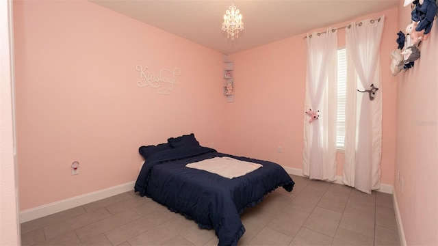 12458 Fish Cove Dr, Spring Hill, FL 34609 - bedroom featuring multiple windows, a chandelier, and baseboards