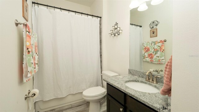 12458 Fish Cove Dr, Spring Hill, FL 34609 - full bathroom with toilet, vanity, shower / bathtub combination with curtain, and wood finished floors