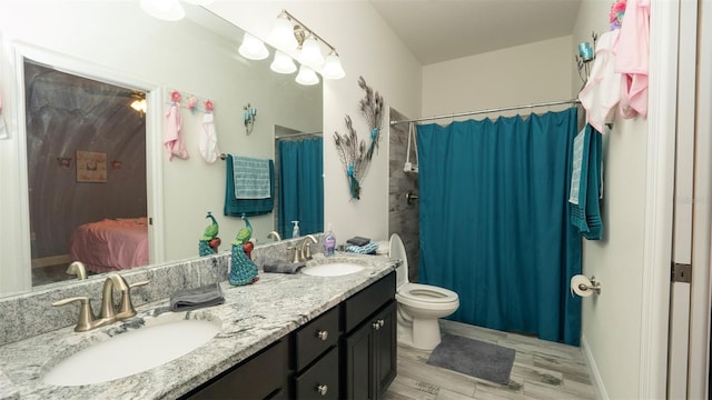 12458 Fish Cove Dr, Spring Hill, FL 34609 - ensuite bathroom with double vanity, toilet, and a shower with shower curtain