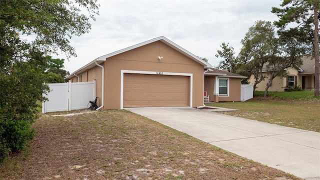 12458 Fish Cove Dr, Spring Hill, FL 34609 - ranch-style house with a garage, stucco siding, and driveway