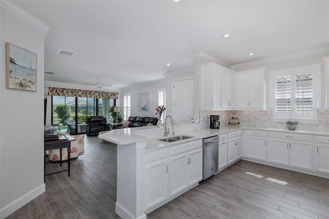 3051 Francoa Dr, Odessa, FL 33556 - kitchen with stainless steel dishwasher, a sink, ornamental molding, a peninsula, and wood finished floors