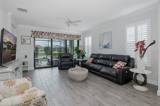 3051 Francoa Dr, Odessa, FL 33556 - living area featuring wood finished floors, baseboards, crown molding, and ceiling fan