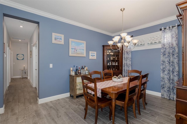 3051 Francoa Dr, Odessa, FL 33556 - dining room with a chandelier, wood finished floors, baseboards, and crown molding