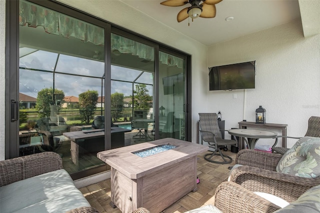 3051 Francoa Dr, Odessa, FL 33556 - sunroom featuring an outdoor fire pit, a ceiling fan, wood finished floors, and a textured wall